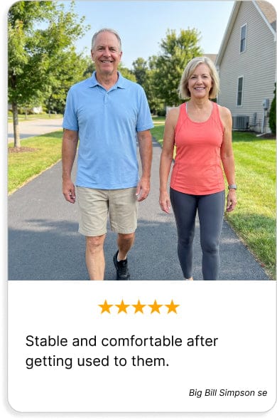 Active couple walking on a paved path. Man wears a light blue polo and khaki shorts; woman wears a coral tank and gray leggin