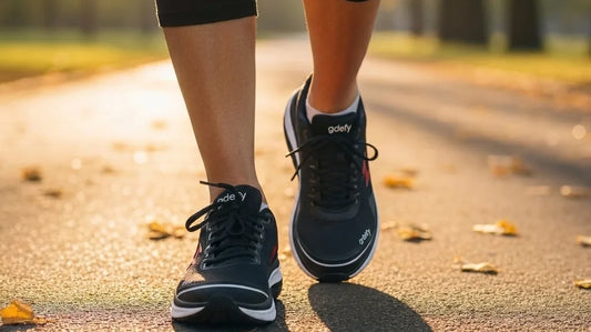 Close-up of fresh G-Defy Mighty Walk walking shoes mid-stride on a sunlit autumn park path