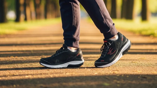 A dad walking on a sunlit park path in supportive G-Defy Mighty Walk shoes