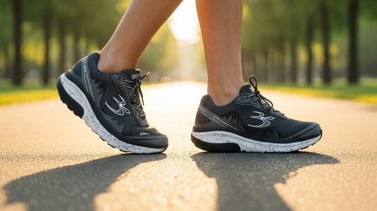 Close view of a walker's legs and cushioned G-Defy Mighty Walk walking shoes mid-stride on a sunlit park path during a long walk