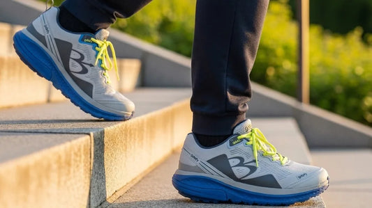 Close-up of G-Defy Mighty Walk walking shoes stepping down stone park steps, showing the cushioned rocker midsole