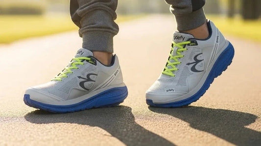 Men's G-Defy Mighty Walk gray-blue athletic walking shoes mid-stride on a sunlit path, feet-level view