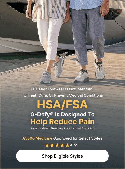 Two people wearing G-Defy grey and white sneakers walk on a dock. G-Defy footwear is HSA/FSA eligible and Medicare-Approved t
