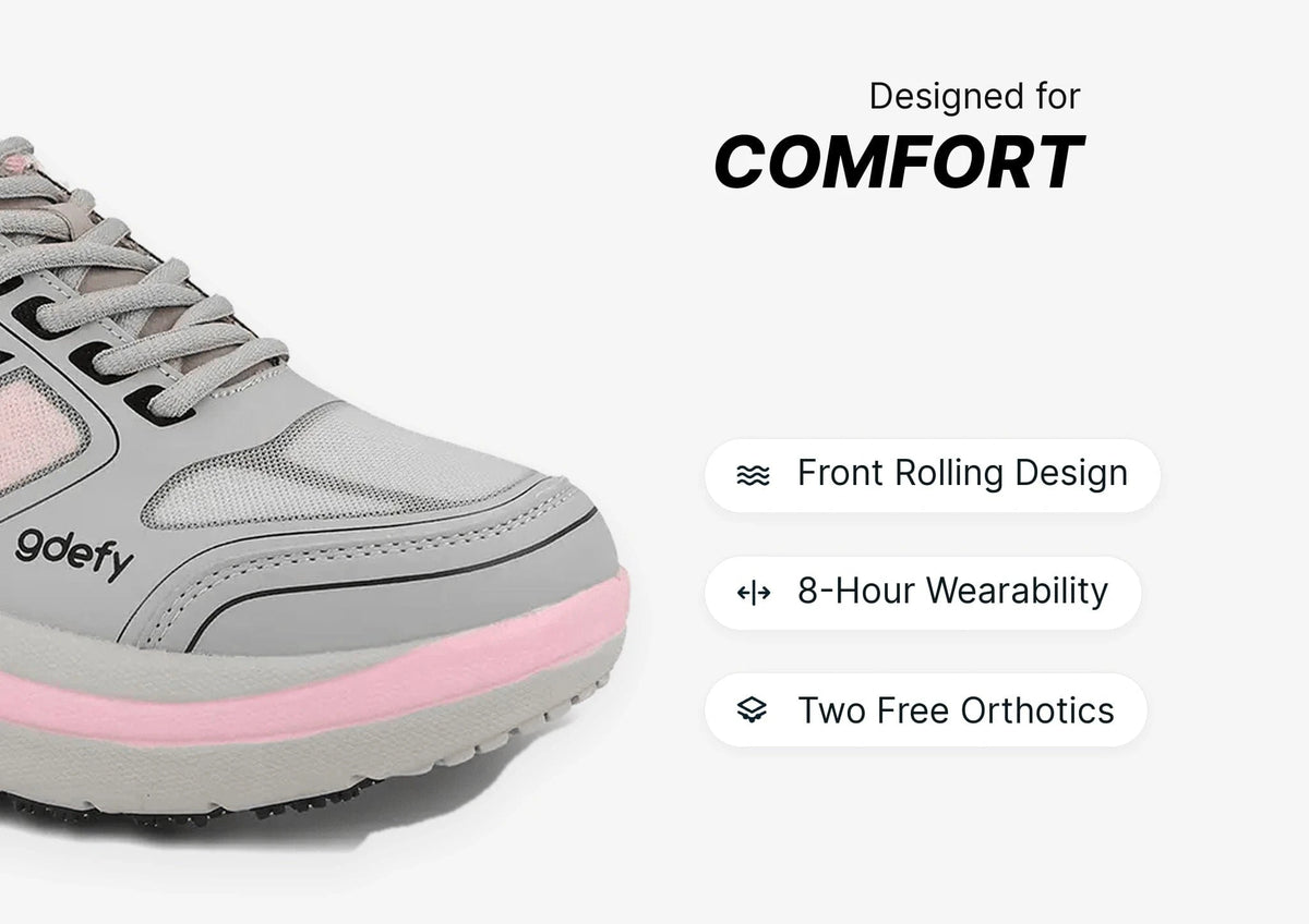Grey and pink gdefy comfort sneaker with mesh upper and thick sole, highlighting its front rolling design.