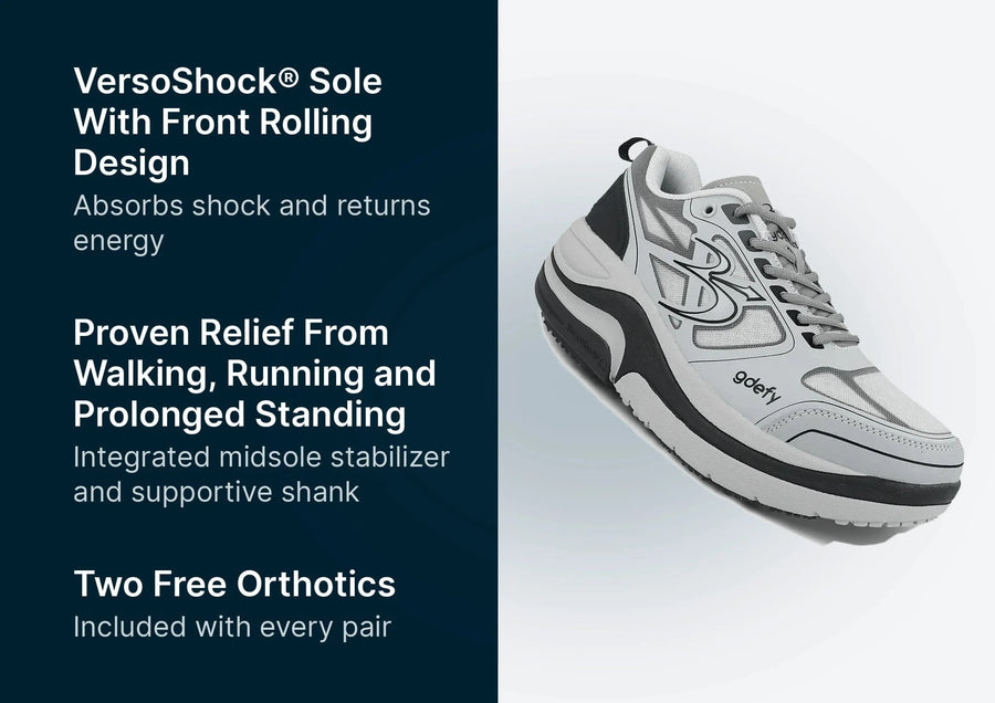 White and grey athletic shoe with black accents, mesh upper, and thick VersoShock sole, angled to show its design.