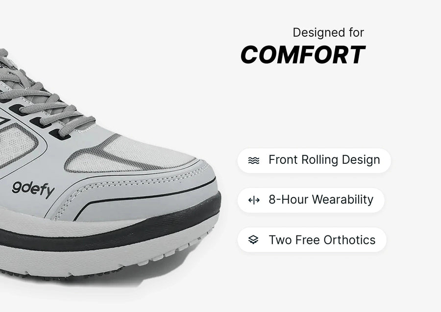 White and grey GDefy athletic shoe with thick sole, designed for comfort with front rolling design and 8-hour wearability.