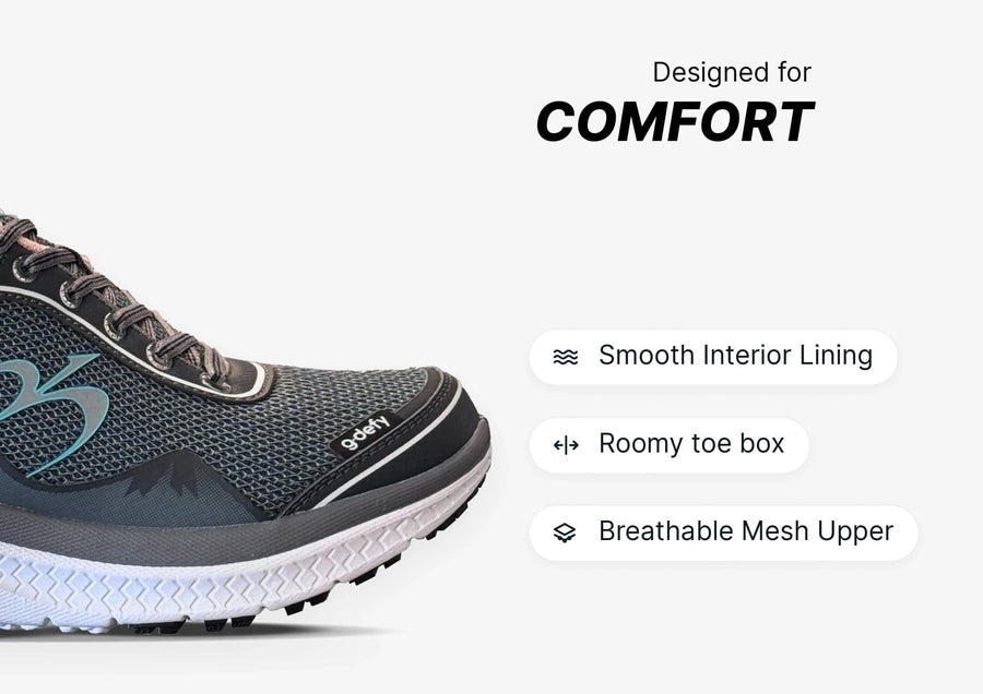 Grey and black g-defy athletic shoe with breathable mesh upper and white sole, highlighting comfort features.