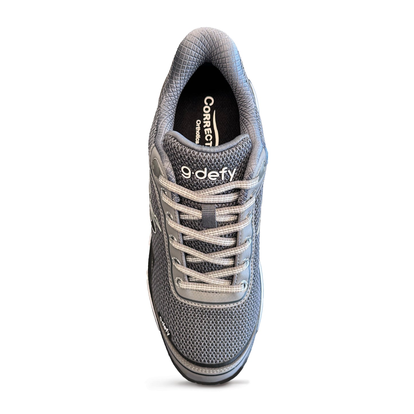 Top view of a gray mesh athletic shoe featuring gray laces, '9 defy' branding, and a 'Correct Orthotics' insole.
