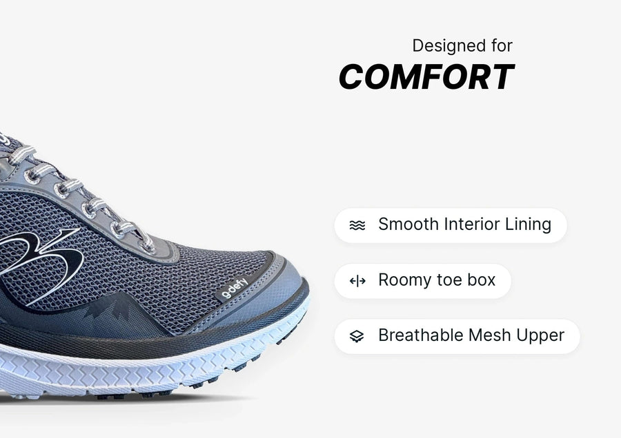 Grey athletic shoe with a breathable mesh upper, roomy toe box, and smooth interior lining, designed for comfort.