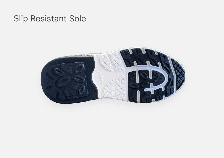 Shoe outsole with black and white slip-resistant tread pattern for enhanced grip and stability.