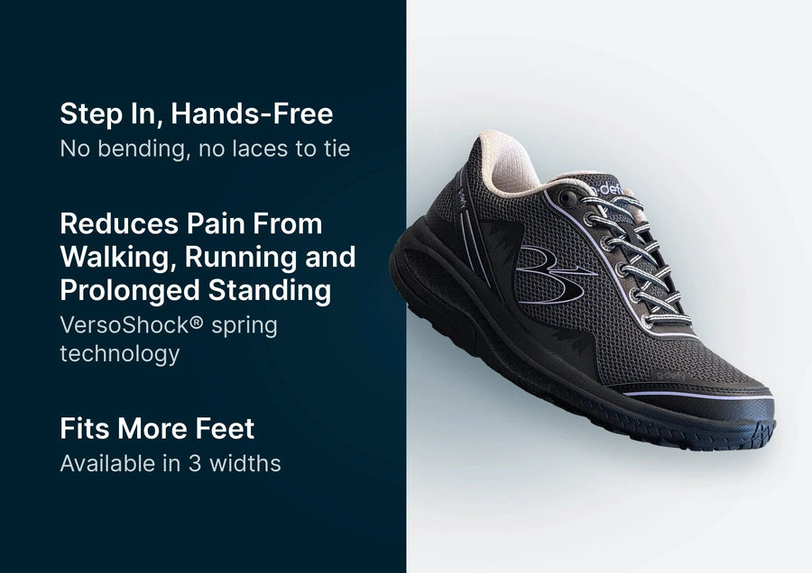 Black g-defy athletic shoe with a mesh upper, white inner lining, and striped elastic laces, presented on a light background.