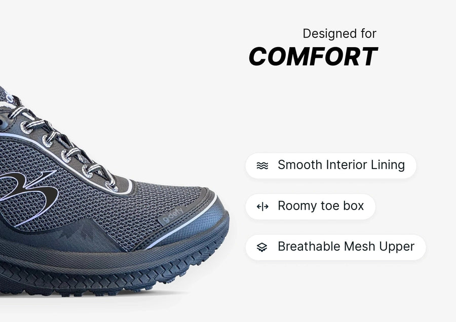 Dark grey athletic shoe with a breathable mesh upper, roomy toe box, and smooth interior lining for comfort.