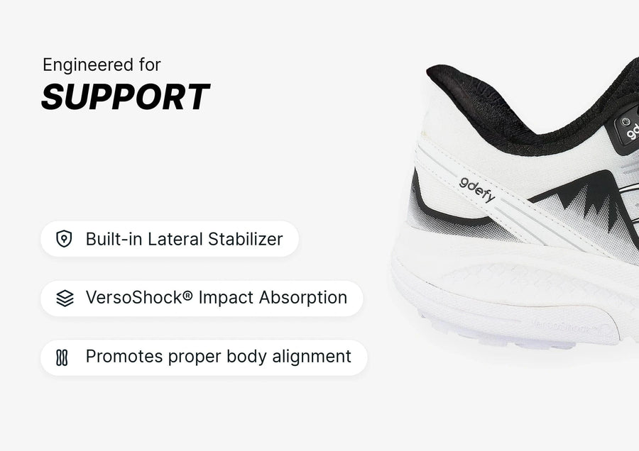 White and black athletic shoe with 'gdefy' branding, highlighting its built-in lateral stabilizer and VersoShock® impact abso