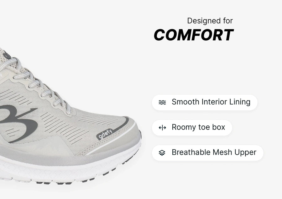 Light gray athletic shoe with breathable mesh upper, smooth interior lining, and a roomy toe box for comfort.
