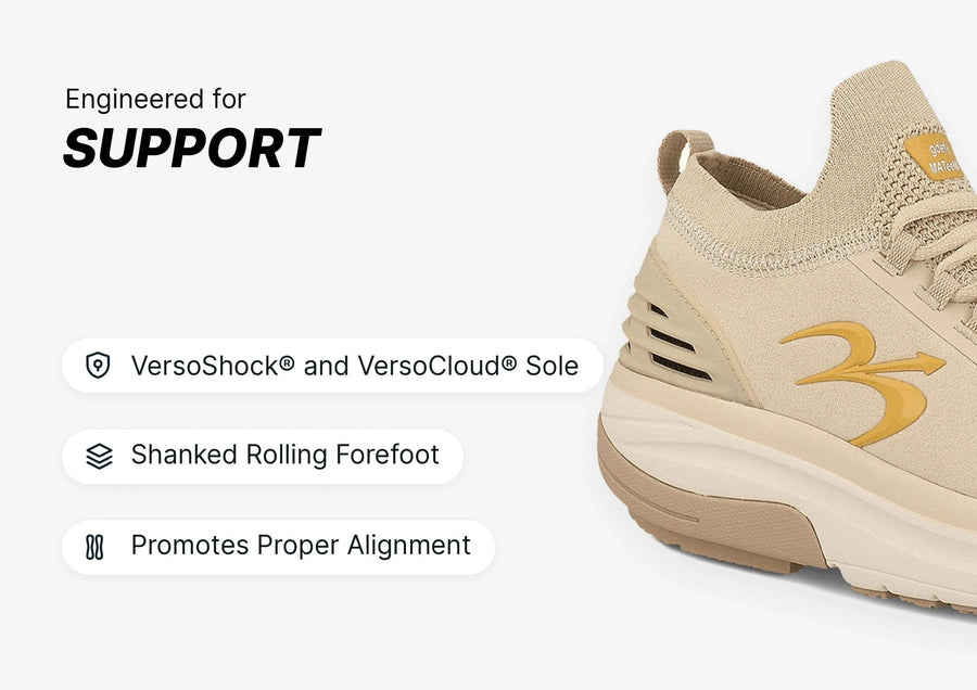Beige athletic shoe with a knitted upper and suede accents, featuring a thick VersoShock and VersoCloud sole for support.