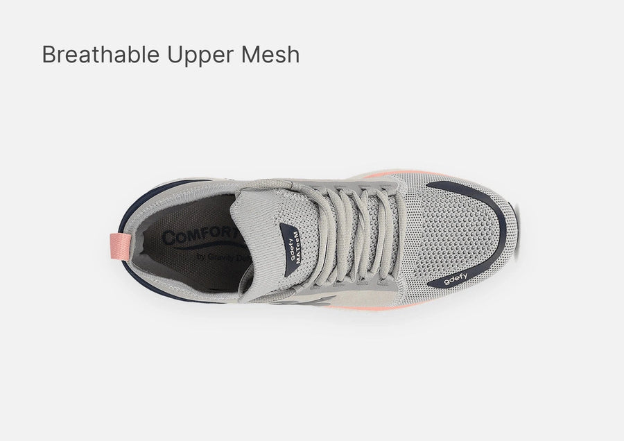 Grey athletic shoe with breathable mesh upper, navy trim, and pink accents, shown from a top-down view.