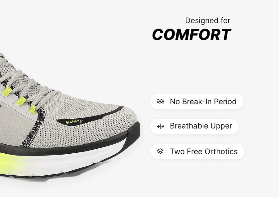 Grey and neon yellow athletic shoe with mesh upper, highlighting comfort features like breathability and included orthotics.