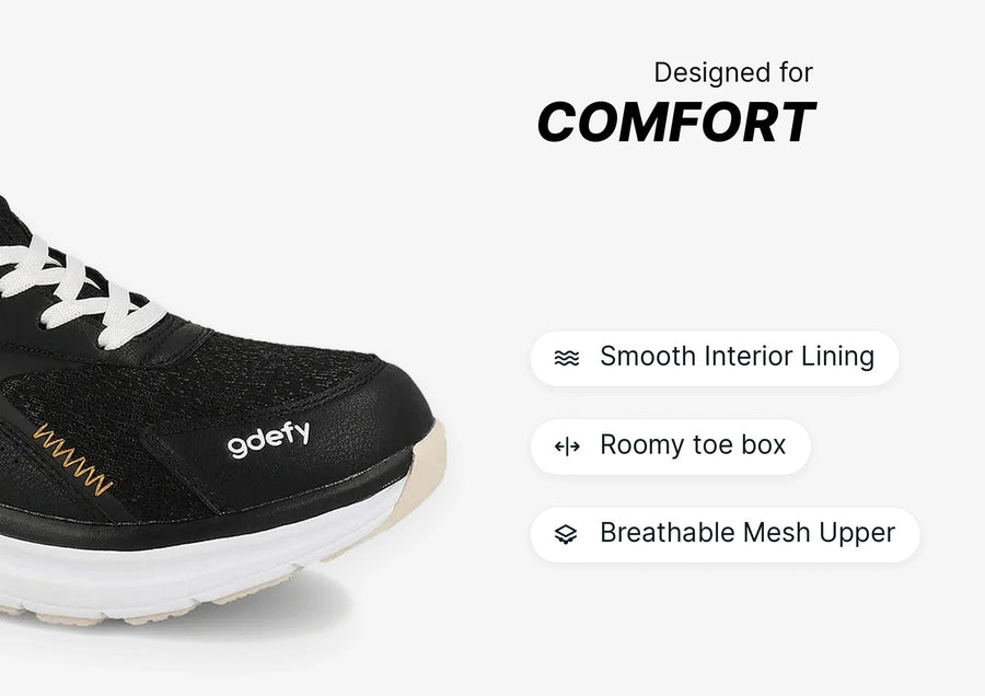 Black gdefy sneaker with white laces and sole, featuring a breathable mesh upper, smooth interior, and roomy toe box for comf