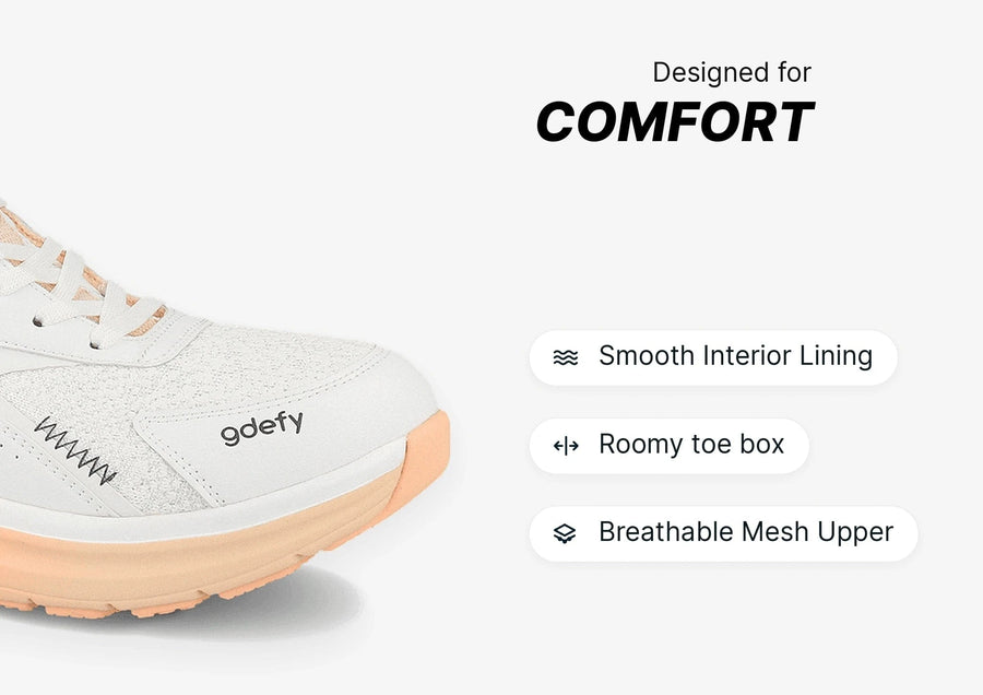 White and peach gdefy running shoe with breathable mesh upper, smooth interior lining, and roomy toe box for comfort.