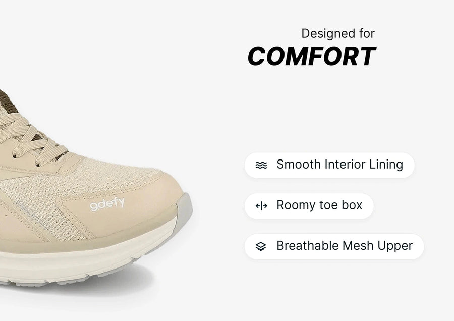 Beige GDefy sneaker with a breathable mesh upper, smooth interior lining, and roomy toe box for comfort.