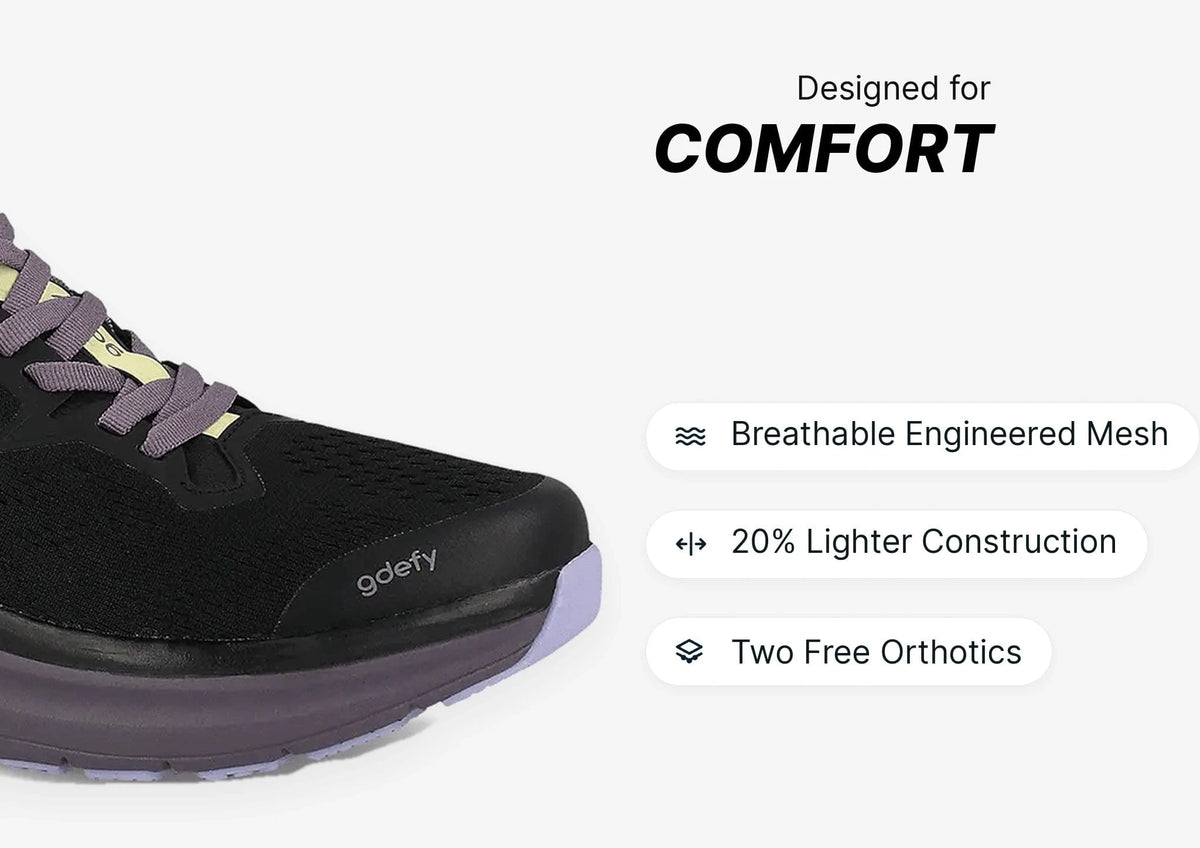 Black running shoe with purple laces and sole, highlighting breathable engineered mesh and lighter construction for comfort.