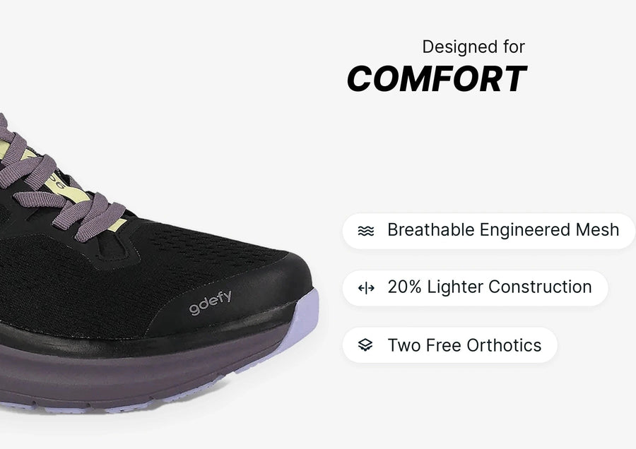 Black running shoe with purple laces and sole, highlighting breathable engineered mesh and lighter construction for comfort.