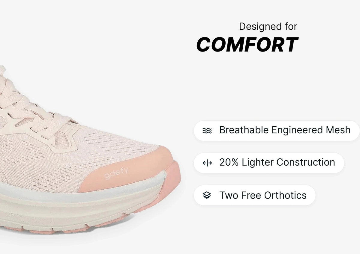Light pink athletic shoe with breathable engineered mesh upper, thick sole, and lightweight construction for comfort.