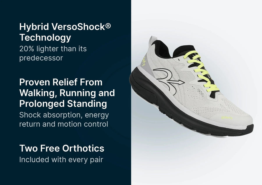 Light grey athletic shoe with a mesh upper, black sole, and bright neon yellow laces.
