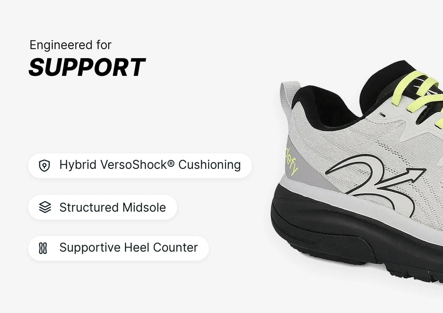 Light gray athletic shoe with black sole and neon yellow laces, showcasing VersoShock cushioning and support features.