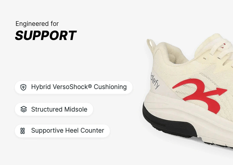 White athletic shoe with red logo and black sole, highlighting engineered support features like structured midsole and cushio