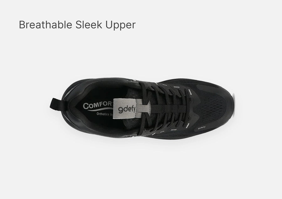 Black athletic shoe with a breathable mesh upper and sleek design. Features laces and a gdefy logo on the tongue, top-down vi
