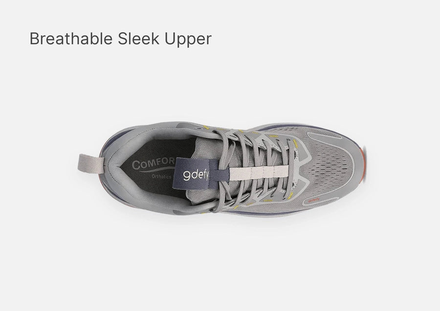 Grey athletic shoe with a breathable mesh upper, yellow accents, and white laces, viewed from above.