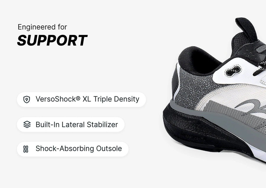 Black, white, and grey running shoe, side view, featuring a thick, shock-absorbing outsole and built-in lateral stabilizer fo