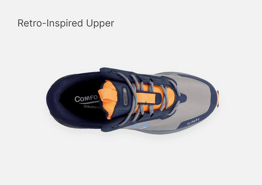 Athletic shoe with grey mesh upper, navy blue overlays, orange tongue, and grey laces, top-down view.