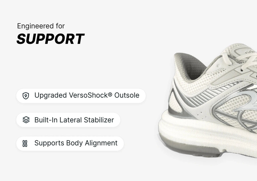 White and silver athletic shoe, side view, showcasing its support features including an upgraded VersoShock® Outsole.
