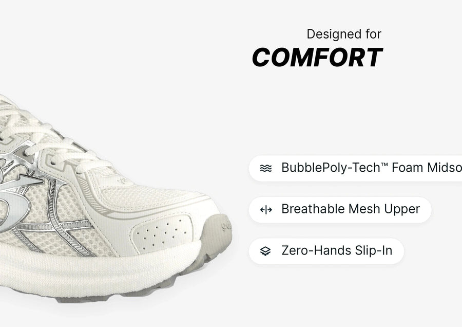 White sneaker with breathable mesh upper, silver accents, thick foam midsole, designed for comfort.
