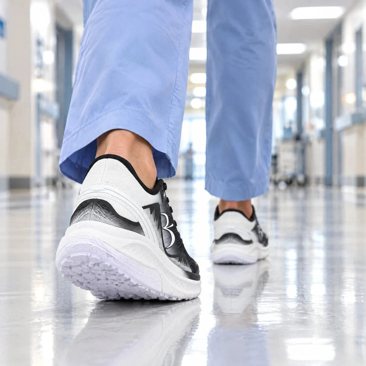 Rear-view illustrative scene of a woman in blue scrubs walking in GDEFY shoes along a bright corridor