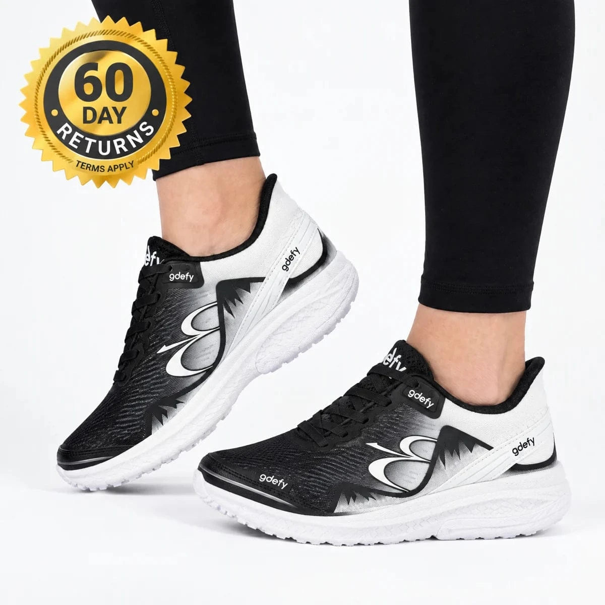GDEFY footwear in an illustrative on-foot studio scene with a 60-day returns seal and terms-apply wording